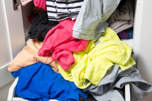 Electric low-emission vans parked ready for skip collection in Forest Gate